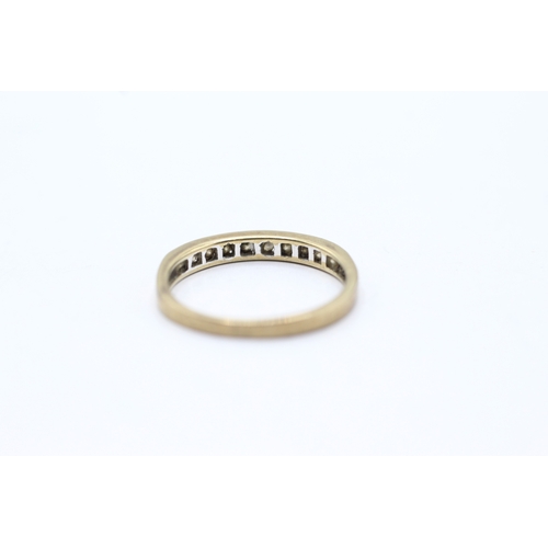 79 - 9ct gold diamond channel set ring (1.3g) Size L