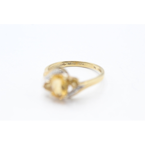 81 - 9ct gold yellow gemstone and diamond ring (2.5g) Size Q 1/2