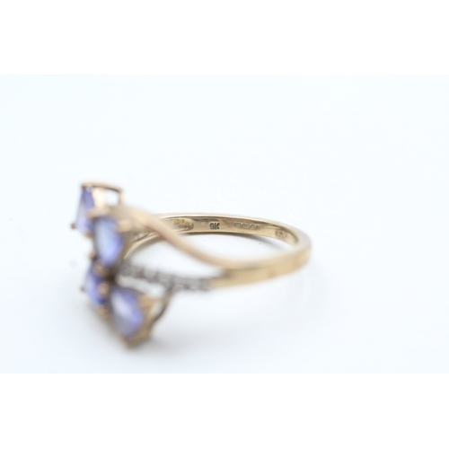 179 - 9ct gold diamond and tanzanite twist ring (3.5g) Size N 1/2