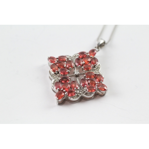 48 - 9ct gold diamond and red gemstone pendant on chain