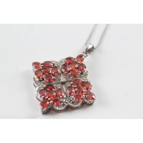 48 - 9ct gold diamond and red gemstone pendant on chain