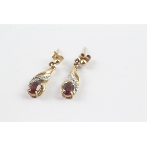 57 - 9ct gold garnet and diamond drop stud earrings