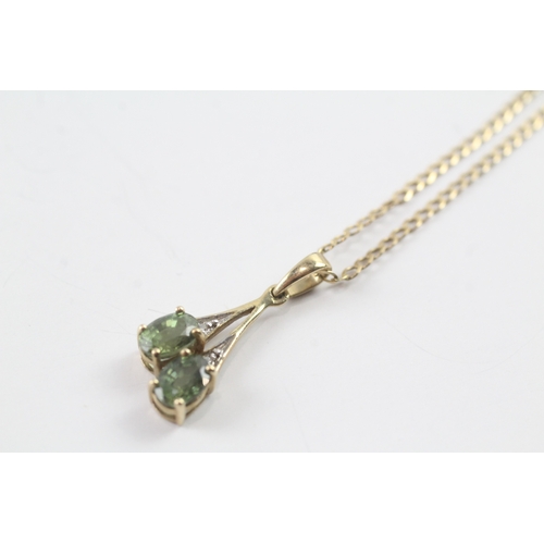 62 - 9ct gold diamond and green gemstone pendant on chain