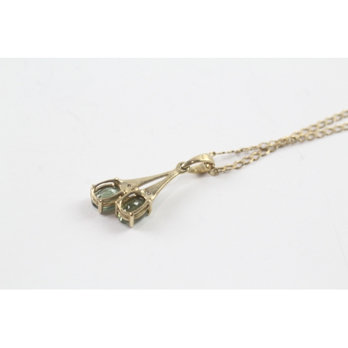 62 - 9ct gold diamond and green gemstone pendant on chain