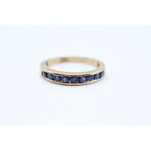 71 - 9ct gold and sapphire channel set ring (2.5g) Size O