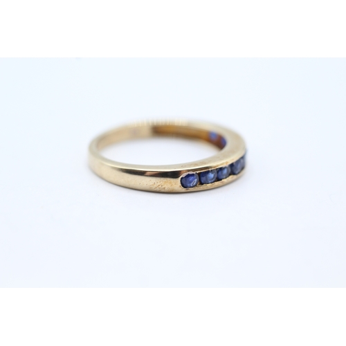 71 - 9ct gold and sapphire channel set ring (2.5g) Size O