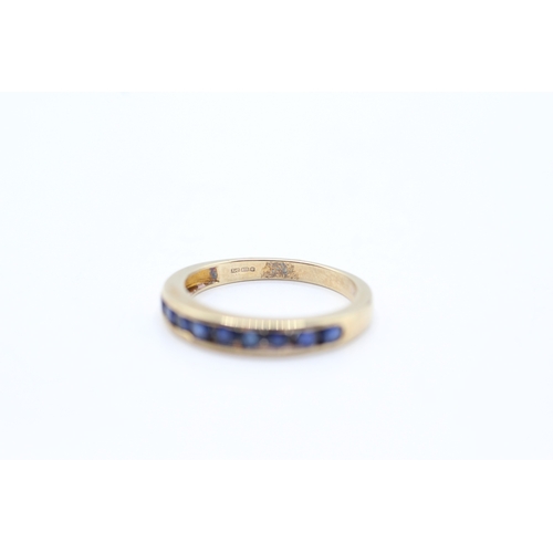 71 - 9ct gold and sapphire channel set ring (2.5g) Size O