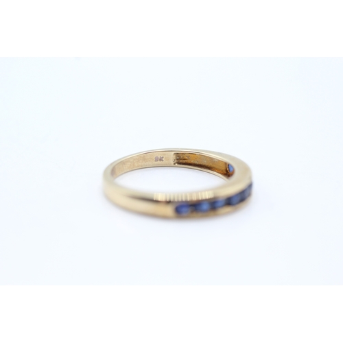 71 - 9ct gold and sapphire channel set ring (2.5g) Size O