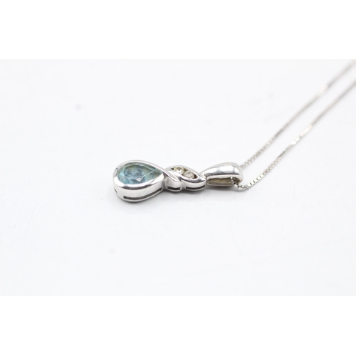 113 - 9ct gold blue gemstone pendant on chain (1.8g)