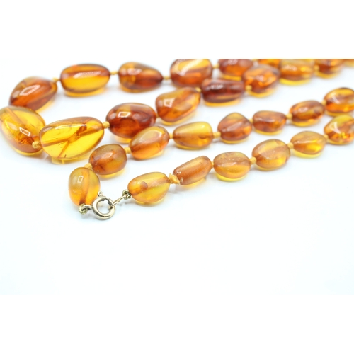 239 - 9ct gold amber necklace (63.7g)