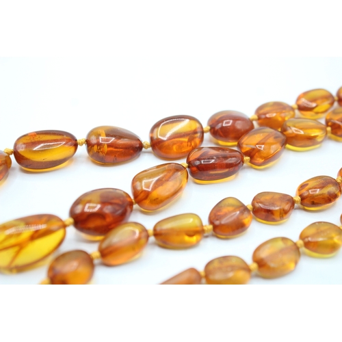 239 - 9ct gold amber necklace (63.7g)