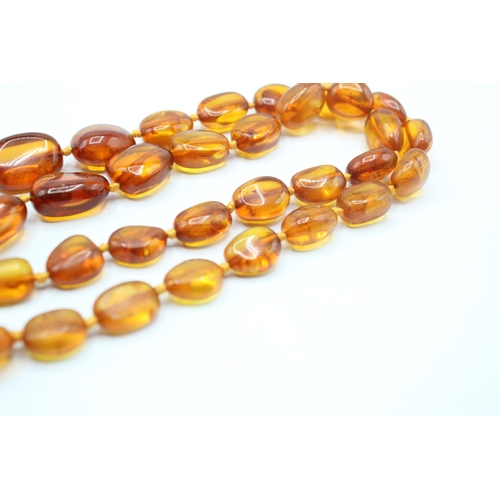 239 - 9ct gold amber necklace (63.7g)