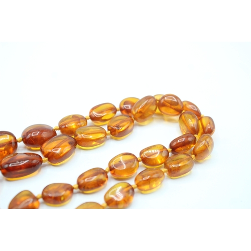 239 - 9ct gold amber necklace (63.7g)