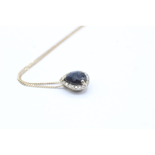 116 - 9ct gold sapphire and diamond halo pendant on chain (1.5g)