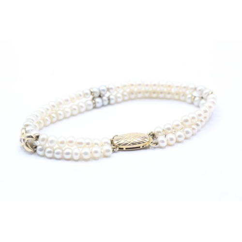 130 - 9ct gold cultured pearl and diamond bracelet (12.1g)