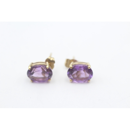 22 - 9ct gold oval cut amethyst stud earrings (2.1g)