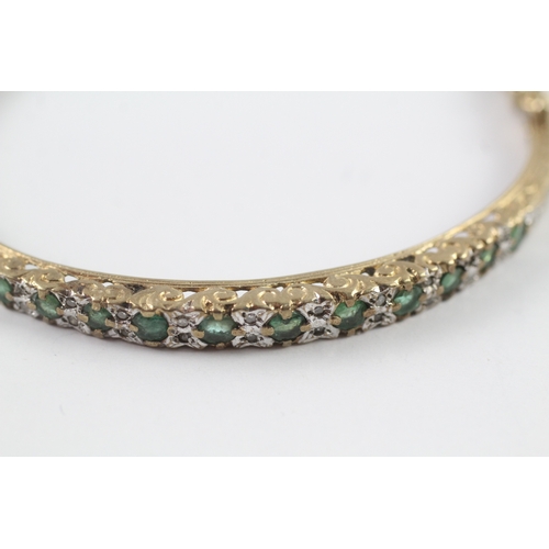 249 - 9ct gold emerald and diamond bangle (12.2g)