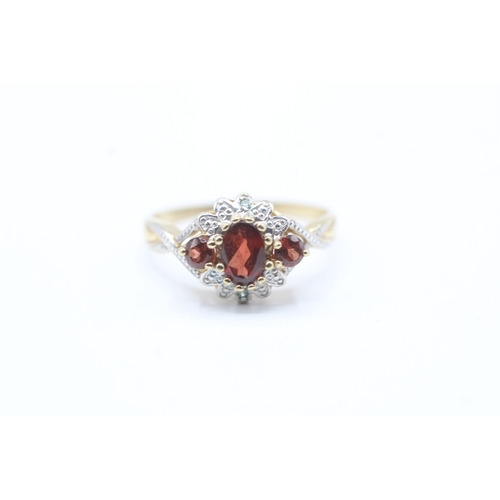 52 - 9ct gold diamond and red gemstone halo ring (2g) Size P