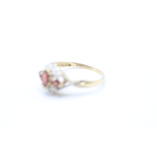 52 - 9ct gold diamond and red gemstone halo ring (2g) Size P