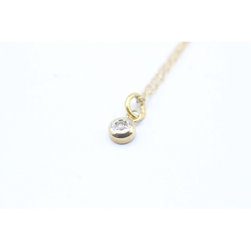 66 - 9ct gold single diamond pendant on chain (1.2g)