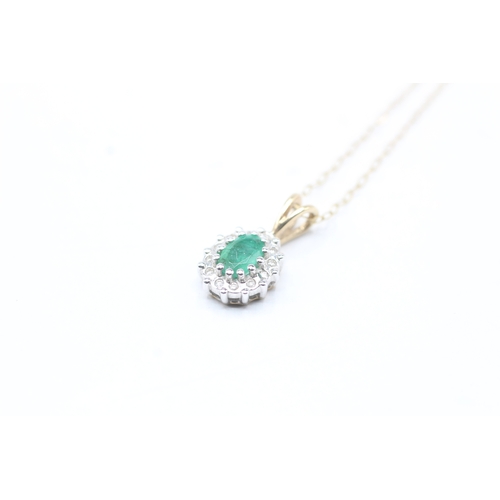 71 - 9ct gold emerald and diamond halo pendant on chain (1.6g)