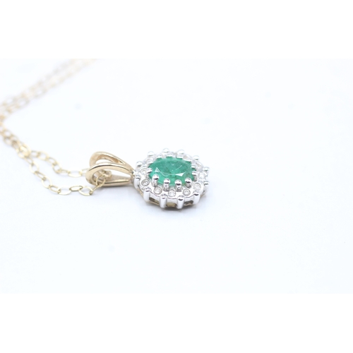 71 - 9ct gold emerald and diamond halo pendant on chain (1.6g)