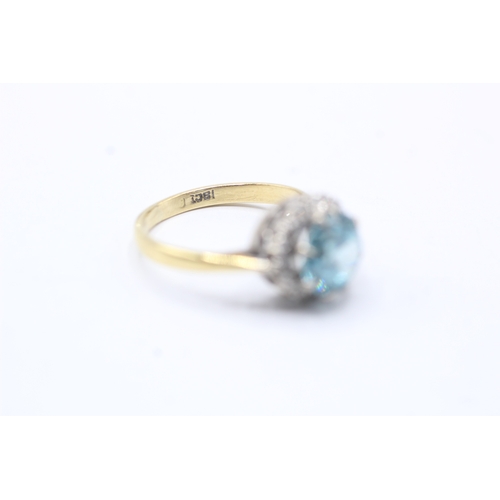 75 - 18ct gold diamond and blue gemstone halo ring (3.7g) Size L