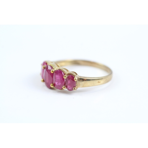 83 - 9ct gold oval cut ruby five stone ring (2.7g) Size P