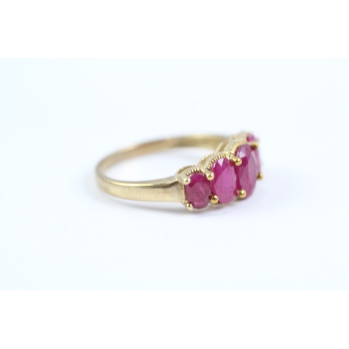 83 - 9ct gold oval cut ruby five stone ring (2.7g) Size P