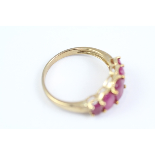 83 - 9ct gold oval cut ruby five stone ring (2.7g) Size P