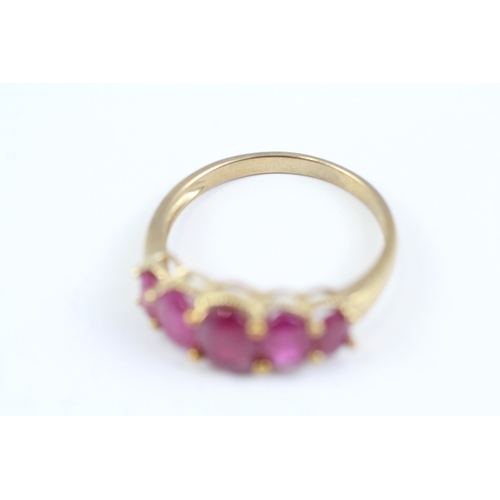 83 - 9ct gold oval cut ruby five stone ring (2.7g) Size P