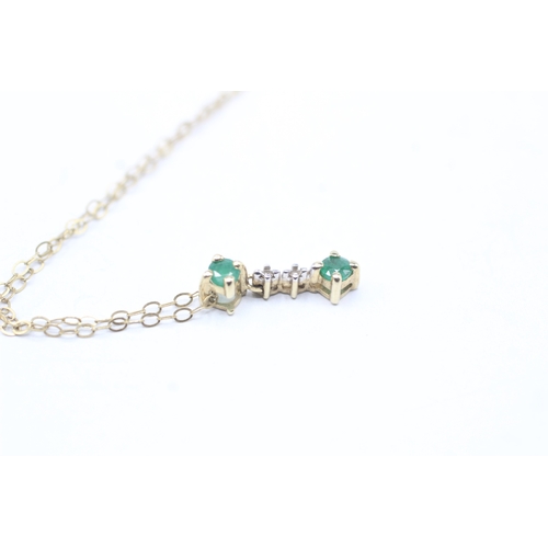 86 - 9ct gold emerald and diamond bar pendant on chain (0.9g)