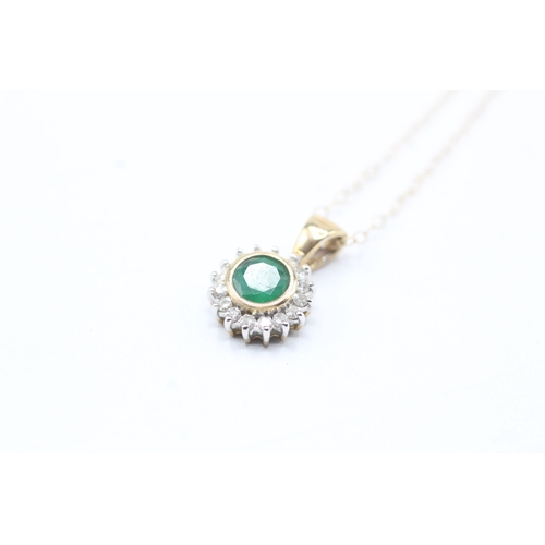 87 - 9ct gold emerald and diamond halo pendant on chain (1.5g)