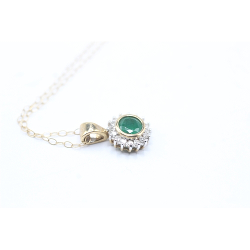 87 - 9ct gold emerald and diamond halo pendant on chain (1.5g)