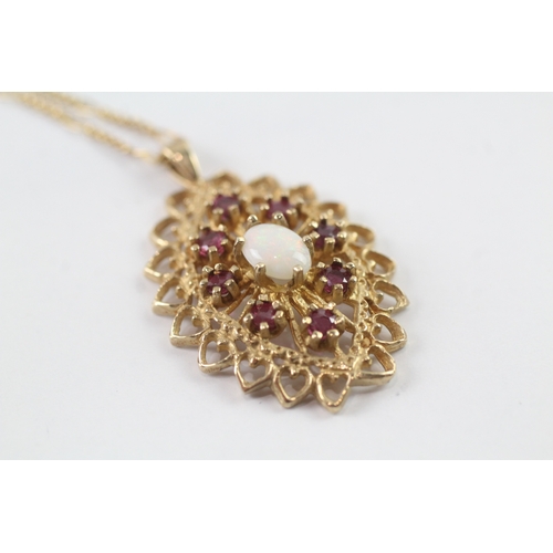 204 - 9ct gold opal and ruby cluster pendant w/ 9ct gold chain (5g)