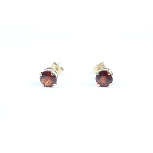 167 - 9ct gold round cut red gemstone solitaire stud earrings (0.5g)