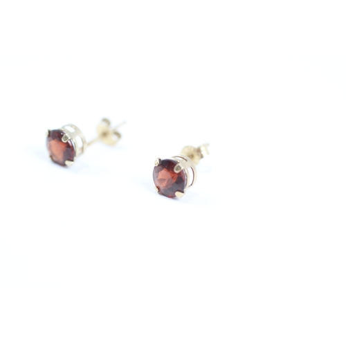 167 - 9ct gold round cut red gemstone solitaire stud earrings (0.5g)