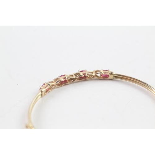 19 - 9ct gold oval cut ruby & diamond bangle (3.9g)