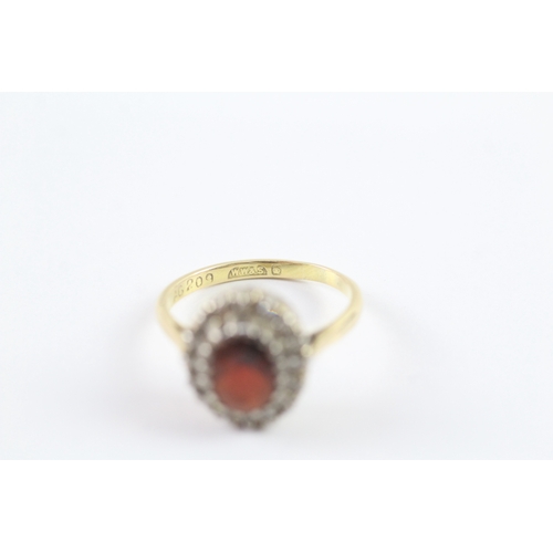 23 - 18ct gold garnet and diamond halo dress ring Size O