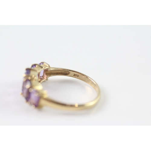 50 - 9ct gold graduated amethyst five stone dress ring (2.2g) Size P