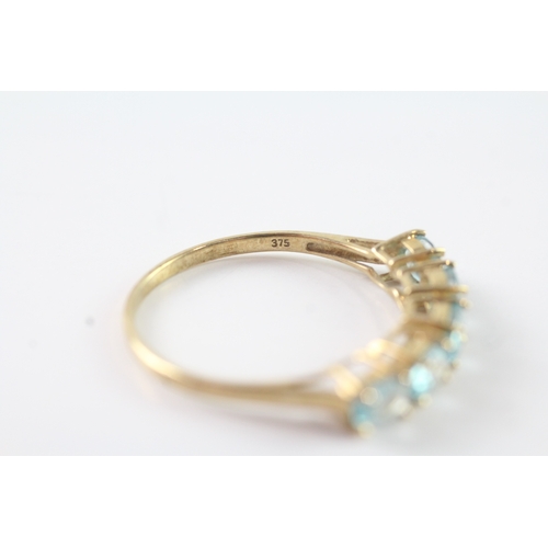 62 - 9ct gold oval cut blue gemstone half eternity ring (2.2g) Size V