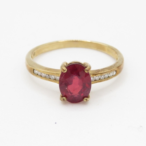 61 - 9ct gold oval cut red gemstone & diamond dress ring (1.7g) Size N