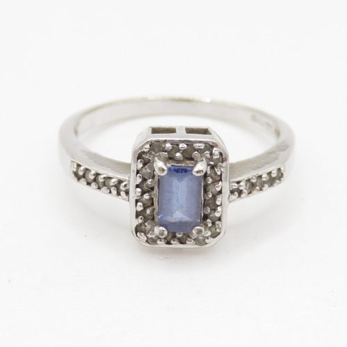 73 - 9ct white gold blue gemstone and diamond halo dress ring w/ diamond set shoulders (2.1g) Size L