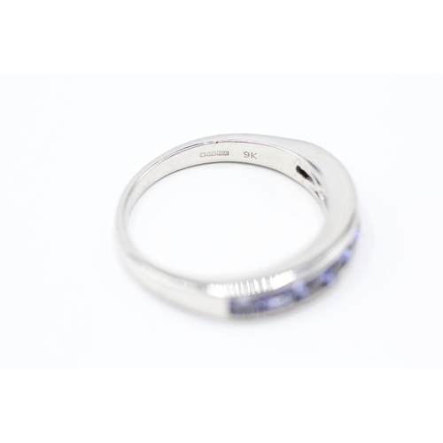 143 - 9ct white gold tanzanite half eternity ring (3.7g) Size R