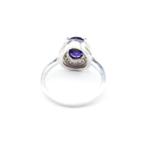 144 - 10ct white gold blue gemstone & diamond halo dress ring (4.6g) Size R 1/2