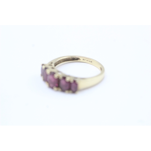 170 - 9ct gold oval cut purple gemstone five stone ring (2.7g) Size O 1/2