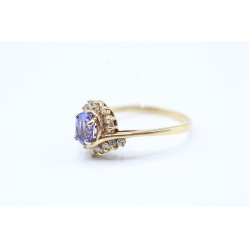 216 - 14ct gold diamond and tanzanite twist ring (2.2g) Size N