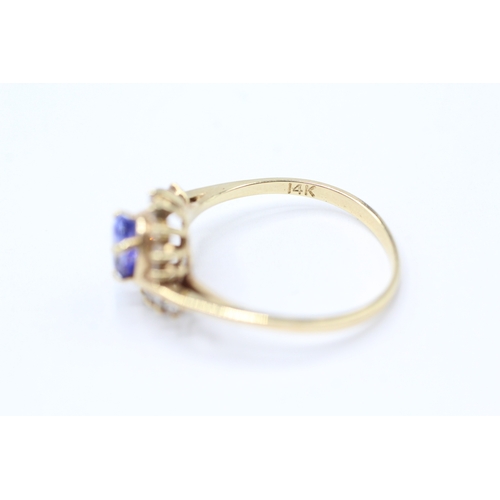 216 - 14ct gold diamond and tanzanite twist ring (2.2g) Size N