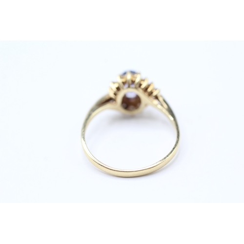 216 - 14ct gold diamond and tanzanite twist ring (2.2g) Size N