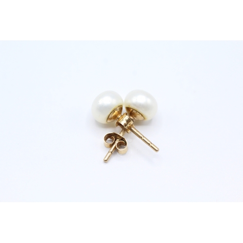 34 - 9ct gold x2 cultured pearl stud earrings (2.1g)